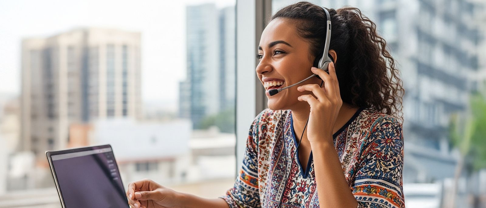 Woman uses voip phone and laptop